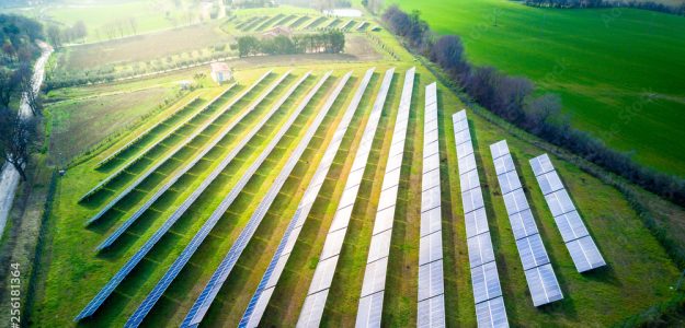 aerial view of solar panels on a sunny day. power farm producing clean energy